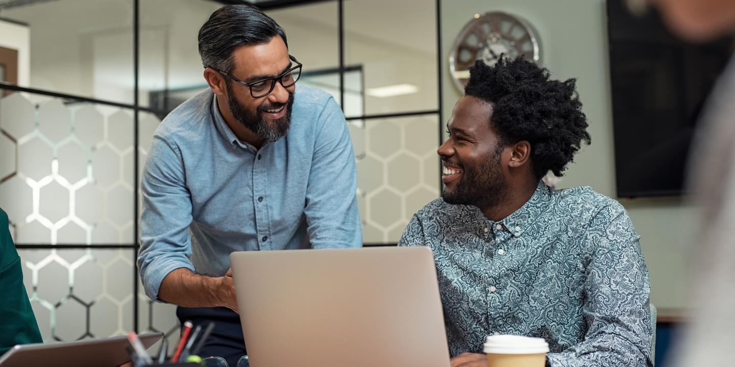 Two Diverse Male Technology Workers Discussing