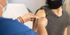 A health care provider places a bandage on the injection site of a patient, who just received a vaccine. Photo by Centers for Disease Control and Prevention (CDC) via Unsplash.