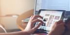 Close up of hands belonging to a white person scrolling on a digital tablet. On the tablet behind the tablet is a laptop computer. Photo by Pixabay via Pexels.com