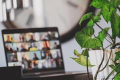 Image of a laptop with several images of people joining a video meeting. Photo by Sigmund Agency via Unsplash.