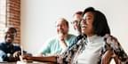 Team woman laughing at meeting table